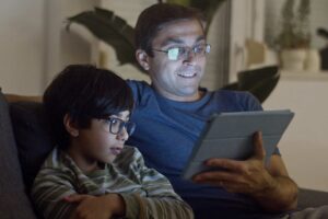 Photo by Kampus Production: https://www.pexels.com/photo/father-and-son-watching-video-7414064/