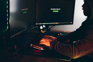 Photo by Anete Lusina: https://www.pexels.com/photo/crop-hacker-silhouette-typing-on-computer-keyboard-while-hacking-system-5240547/