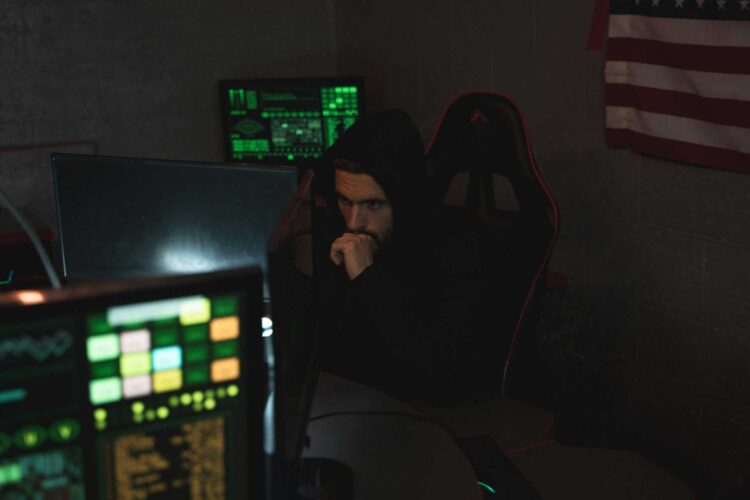 Photo by Tima Miroshnichenko: https://www.pexels.com/photo/man-in-black-hoodie-sitting-on-chair-looking-at-computer-monitor-5380585/