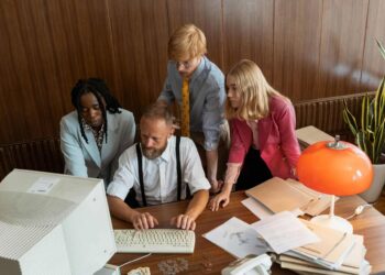Photo by MART PRODUCTION: https://www.pexels.com/photo/team-of-businesspeople-looking-at-a-computer-monitor-8872390/